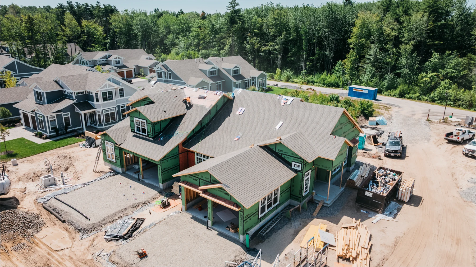 Wide aerial view of several homes under construction