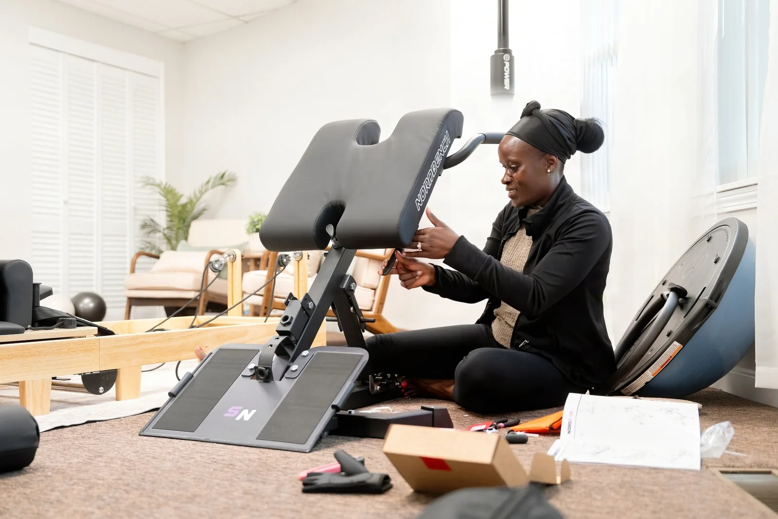 Suubi setting up equipment in the Boon studio